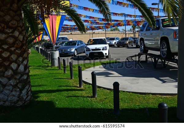 BAKERSFIELD, CA - APRIL 4, 2017: This\
well-maintained used car lot is quiet on a sunny weekday morning.\
Business has been slow\
lately.