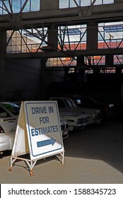 BAKERSFIELD, CA - DECEMBER 12, 2019: An Auto Body Shop Invites Potential Customers To Drive In For A Damage Estimate.