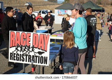 BAKERSFIELD, CA - JAN 11, 2014: An unidentified woman signs up for the race at the 24th Annual Fog Run, misnamed this year since the sun is shining brightly.