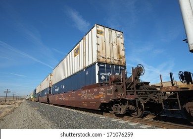 BAKERSFIELD, CA -Â?Â? JAN 11, 2014: Rail Cars Using Versatile Intermodal Transportation Carry Containers Which Can Be Loaded Onto Trucks Or Ships To Complete Their Travel To Destinations.