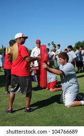 BAKERSFIELD, CA - JUNE 9: Boys Learn The Fundamentals Of The Game At The Golden Empire Youth Football Camp At Bakersfield Community College On June 9, 2012,  In Bakersfield, California.