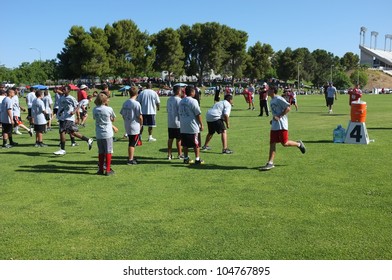 BAKERSFIELD, CA - JUNE 9: Boys Sprint To Get In Shape For The Golden Empire Youth Football Camp At Bakersfield Community College On June 9, 2012,  In Bakersfield, California.