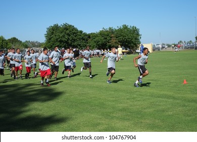 BAKERSFIELD, CA - JUNE 9: Boys Sprint To Get In Shape For The Golden Empire Youth Football Camp At Bakersfield Community College On June 9, 2012,  In Bakersfield, California.