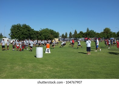 BAKERSFIELD, CA - JUNE 9: Boys Sprint To Get In Shape For The Golden Empire Youth Football Camp At Bakersfield Community College On June 9, 2012,  In Bakersfield, California.