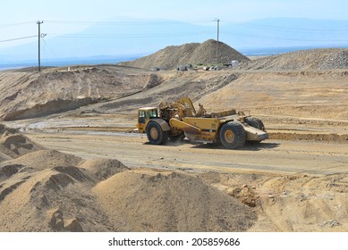 BAKERSFIELD, CA-JULY 18, 2014: A Motor Scraper Helps To Bring The Road Base Up To Grade During The Project To Widen State Route 178.