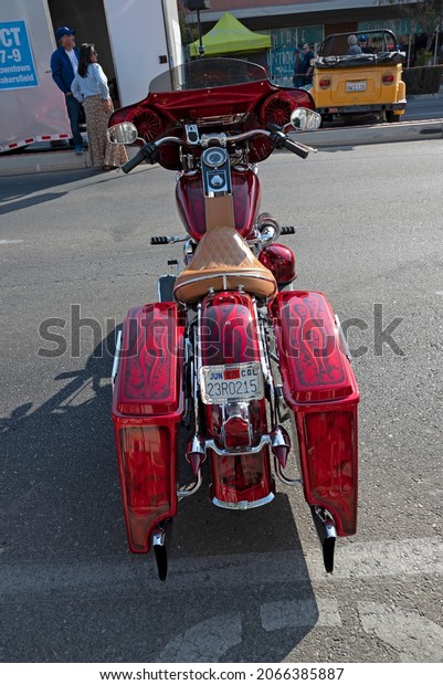 BAKERSFIELD,CA - OCTOBER 9, 2021: Not to be outdone\
by all the autos at the Cruisin 4 Charity car show, this custom\
Harley-Davidson motorcycle features lots of extras and a unique\
paint job.