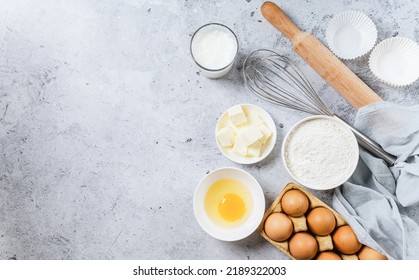 Bakery background. Bake ingredient for recipe Easter cake or dessert, pie. Egg and flour, butter and kitchen textile grey stone table. Top view, copy space. - Powered by Shutterstock