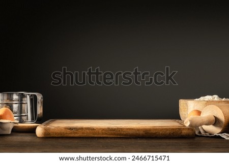 Bakery background, Wooden empty table with board and ingredients for preparing dough on dark background. Place for your product