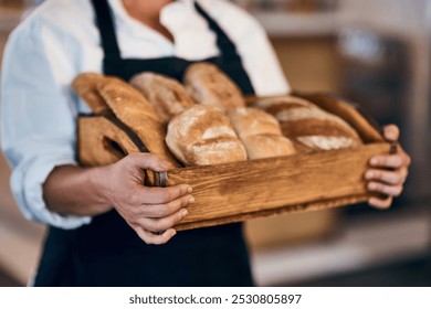 Bakery, box and hands of waiter with bread for serving food, products and pastry for small business. Restaurant, cafeteria and person for service, help and baked goods for hospitality in store - Powered by Shutterstock