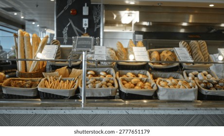 Bakery bread display counter in soft bokeh, shallow focus shop; background backplate copyspace calm.