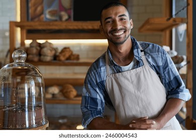 Bakery, cafe and male owner for business, portrait and smile for small scale restaurant and service. Kitchen, pastry and baker for entrepreneur in hospitality, shop and male person for food industry - Powered by Shutterstock