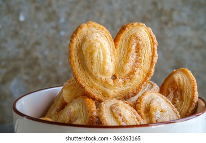 Bakery delicious design from Elephant ear ,Palm leaves, Butterfly shape and Heart about Pies Puff pastry  with butter and  sugar on bowl, Palmier or Coeur de France - Powered by Shutterstock