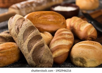 Bakery. Different types of fresh bread on the table. Image with selective focus.