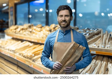 Bakery employee smiling while holding fresh baguettes. Bread section in background with various types of loaves. Concept of friendly customer service and fresh bakery products - Powered by Shutterstock