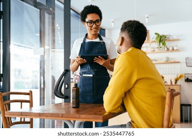 Bakery, happy portrait of black woman in cafe ready for serving pastry, coffee and baked foods. Restaurant, coffee shop and confident waiter barista by counter for service, help and welcome - Powered by Shutterstock