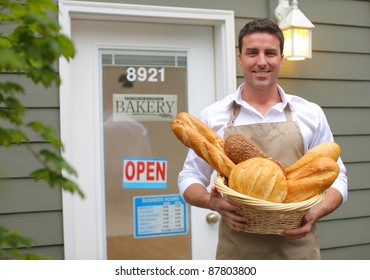 Bakery Owner In Front Of Shop With Bread