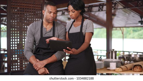 Bakery restaurant workers having a meeting using tablet computer