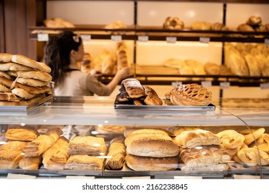 Bakery Shop Interior And Freshly Baked Pastries And Bred On Shelf.