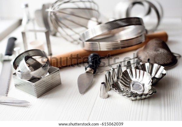 Bakery utensils. Kitchen tools for baking on\
a white wooden\
background.