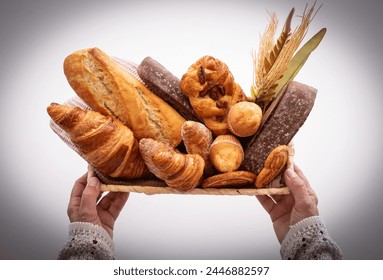 Bakery - various kinds of breadstuff. Rye bread, wholemeal, baguette, sweet bakery products and croissant captured from above (top view, flat lay)