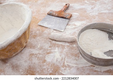 Bakery workbench with spatula, flour basket, sieve and formatted bread. Sao Paulo city, Brazil - Powered by Shutterstock