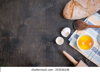 Baking Background With Blank Cook Book, Eggshell, Bread, Flour, Rolling Pin. Vintage Wood Table From Above. Rustic Background With Free Text Space.