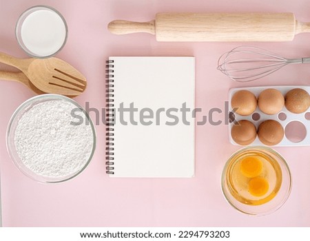 Baking background with blank cook book, eggshell, flour, rolling pin. Free space for text