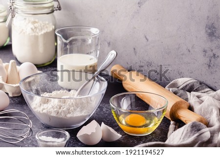 Baking background. Cooking ingredients for dough, eggs, flour, sugar, milk.