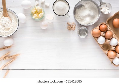 Baking Background With Copy Space. Cooking Ingredients For Dough And Pastry, Eggs, Flour And Butter On White Rustic Wood. Top View, Mockup For Menu, Recipe Or Culinary Classes.