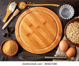 Baking Background With Cutting Board, Eggs, Sugar, Flour And Various Tools, Top View