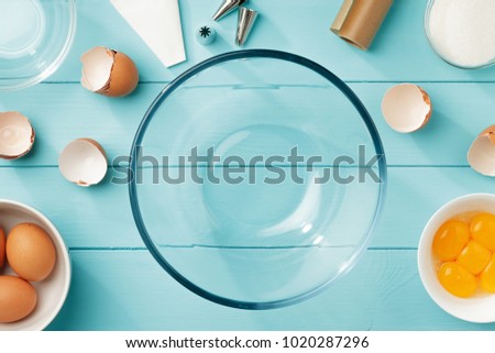 Baking background with eggs and utensils for step by step recipe of meringue flat lay.