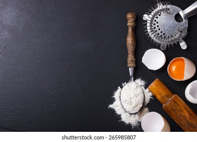 Baking background with eggshell,  flour and rolling pin .selective focus..Copy space.