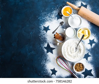 Baking background. Flour, white, brown sugar, eggs, butter, milk, cinnamon sticks, whisk, rolling pin. Ingredients for baking. Kitchen utensils. Space for text. Top view. Making baked goods. Concept