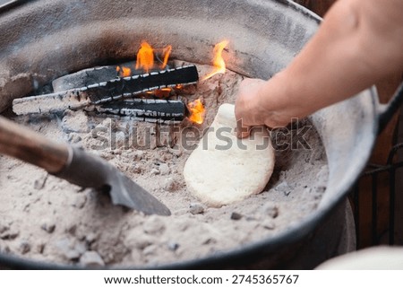 Baking Bread in Ashes Over Wood Fire