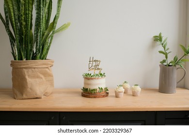 Baking cake with a Happy Birthday topper on the table - Shutterstock ID 2203329367