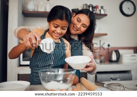 Baking, children and kitchen with a mother and daughter learning about cooking or food in their home together. Family, love and bonding with an indian woman teaching her female child how to bake
