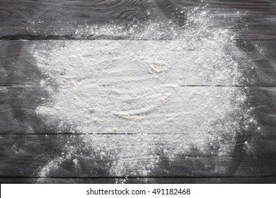 Baking class or recipe concept on dark background, sprinkled wheat flour with free text copy space. Baking preparation, top view on wooden board or table. Cooking dough or pastry. - Shutterstock ID 491182468
