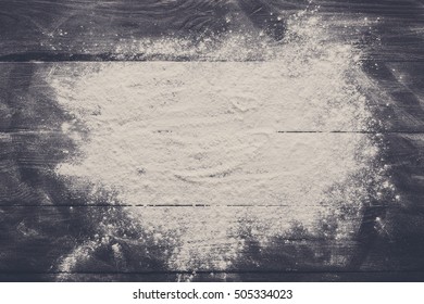 Baking class or recipe concept on dark background, sprinkled wheat flour with free text copy space. Baking preparation, top view on wooden board or table. Cooking dough or pastry. - Shutterstock ID 505334023