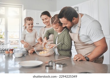 Baking cookies is comforting. Shot of a family baking together in the kitchen. - Powered by Shutterstock