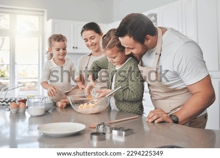 Baking cookies is comforting. Shot of a family baking together in the kitchen.