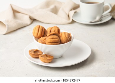 Baking Cookies Shaped Nuts With Condensed Milk In White Bowl And Plate On Grey Background. Close Up, Side View.