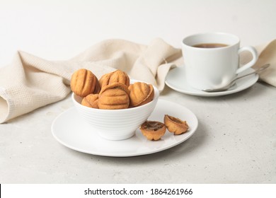 Baking Cookies Shaped Nuts With Condensed Milk In White Bowl And Plate On Grey Background. Close Up, Side View.