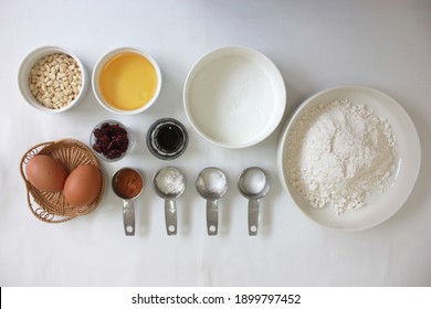 Baking Cooking And Cake Ingredients Flour Eggs Vanilla Powder Bowl Whisk Spatula Butter Cinnamon Powder And Kitchen Textile On White Table Background. Top View. Cookies Pie Or Cake Recipe Mockup