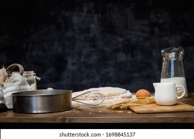 Baking cooking Ingredients flour eggs rolling pin milk and kitchen textile. Side View Copy Space. Delicious food, recipes, cooking, gastronomy, on a dark background and wooden table. - Powered by Shutterstock