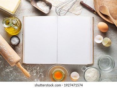 Baking and Cooking Ingredients Flour Eggs Rolling Pin Butter And blank recipe book Background. Top View Copy Space