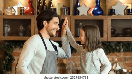 Baking With Dad. Cute Little Girl Giving High Five To Father In Kitchen, Preparing Cookies Together - Powered by Shutterstock