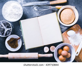 Baking Dark Background With Blank Cook Book, Eggshell, Bread, Flour, Rolling Pin. Ingredients For The Baking.