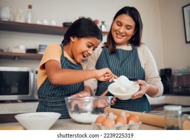 Baking, family and children with a mother and daughter learning about cooking in the kitchen of their home. Food, kids and help with a girl and woman teaching her child how to bake with eggs or flour - Powered by Shutterstock