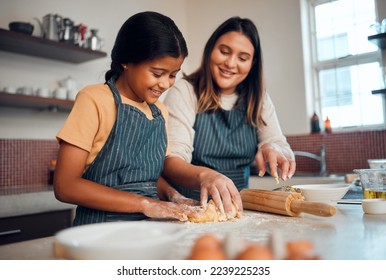 Baking, family and love with a daughter and mother teaching a girl about cooking baked goods in a kitchen. Food, children and learning with an indian woman and girl together in their home to bake - Powered by Shutterstock