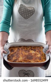 Baking At Home. Girl Holds Lasagna On A Tray